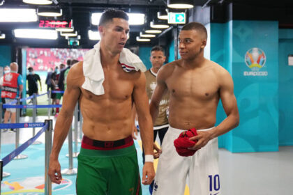 Cristiano Ronaldo of Portugal speaks with Kylian Mbappe of France